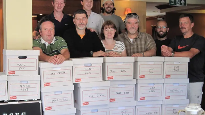 Members of the university research team with some of the data collected from the trials