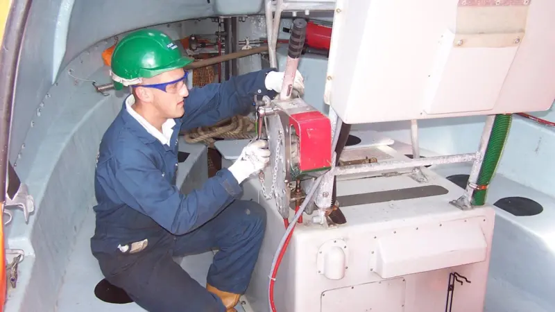 Servicing a Schat-Harding lifeboat hook onboard