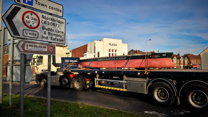 One of the 9m shiphandling training models in transit to its new base