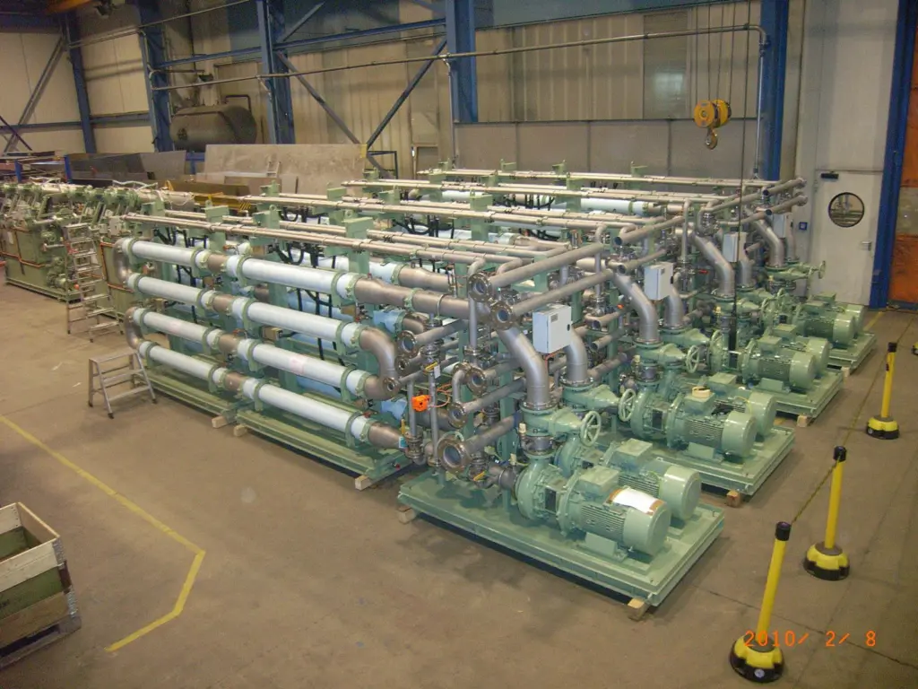 A large Hamworthy MBR system destined for a cruise ship, seen during factory inspection, showing the finished membrane skids in the foreground with the inter-stage filtration units behind