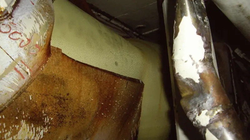 Torn hull pictured from inside showing watertight Miko fabric patch