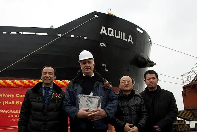 Delivery of ‘ Aquila’: left to right: Zhuang Tian, LR surveyor in charge Nantong; Master - M/V Aquila; Tae-Bok Kwak, LR project manager; Xiaofeng Yang, LR site office team leader