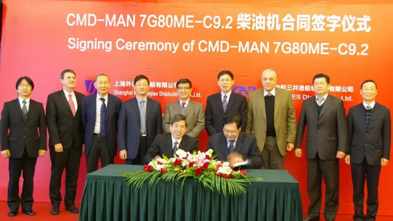 Pictured at the signing ceremony (standing, from left to right): Kimihiko Sugiura – president CMD, Goetz Kassing – managing director, MAN Diesel & Turbo Shanghai, Liu Yanbin – trade relations, Greece-China Association, Wang Yongliang – vice pres...