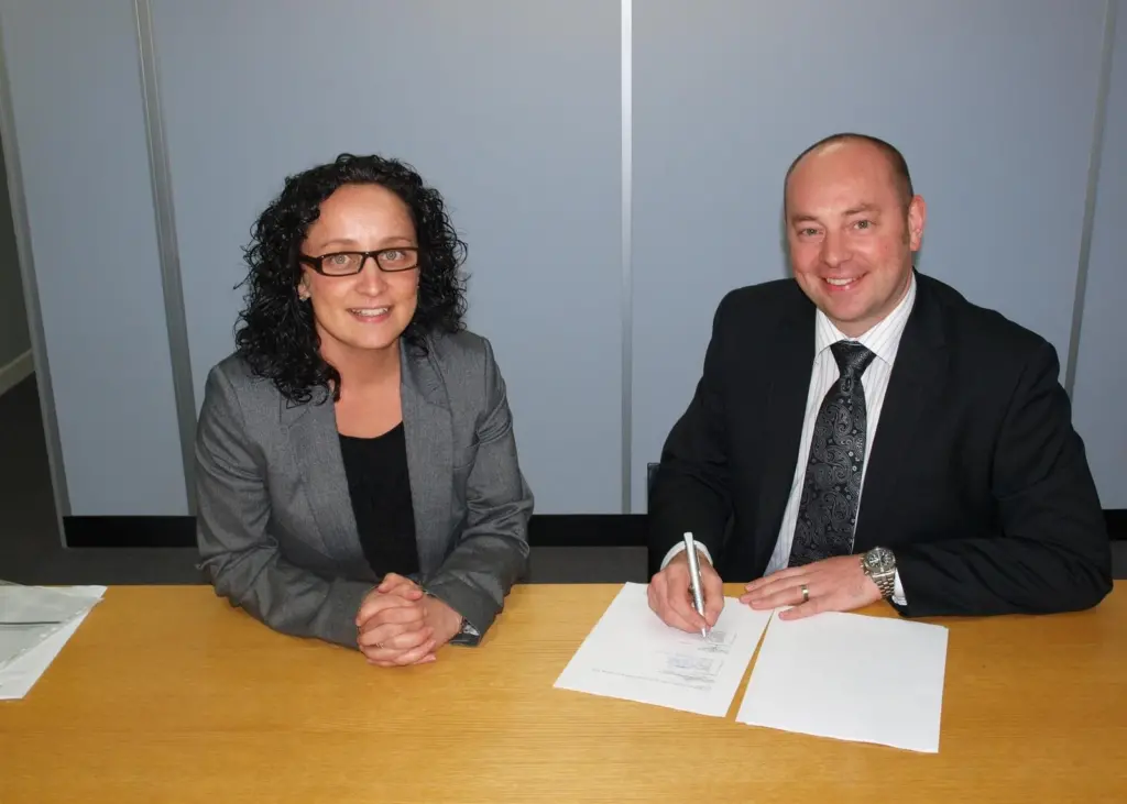 Commercial directors Gary Rodgers of Napier and Sarah Wade of Royston sign the service centre agreement