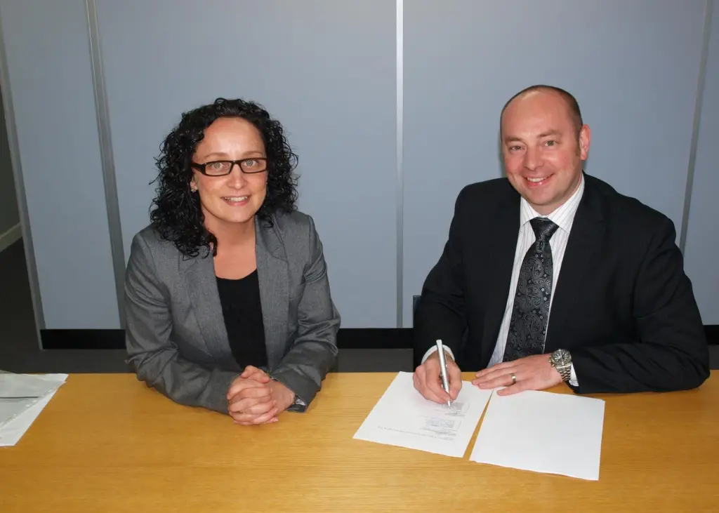 Commercial directors Gary Rodgers of Napier and Sarah Wade of Royston sign the service centre agreement