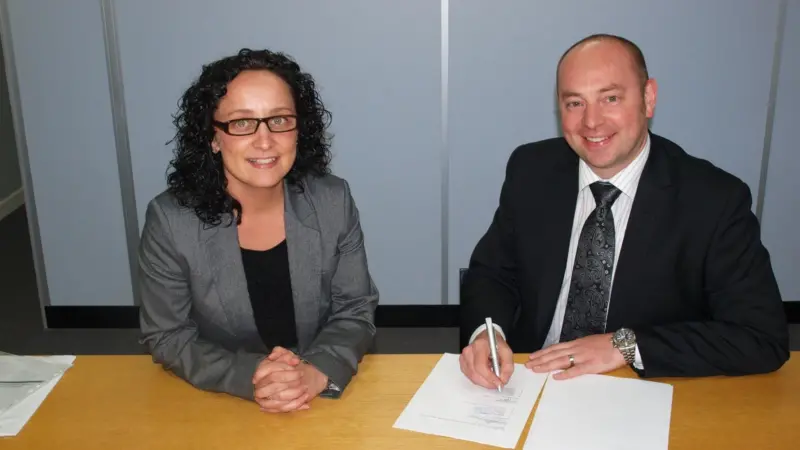 Commercial directors Gary Rodgers of Napier and Sarah Wade of Royston sign the service centre agreement