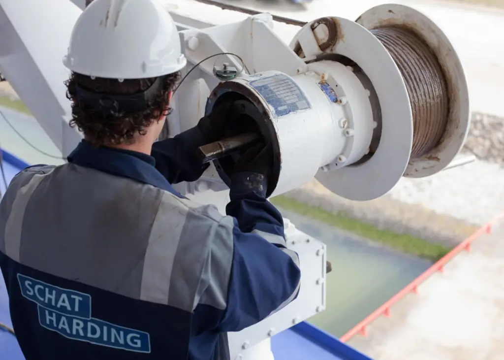 An engineer from Schat-Harding attends to maintenance of lifeboat mechanisms
