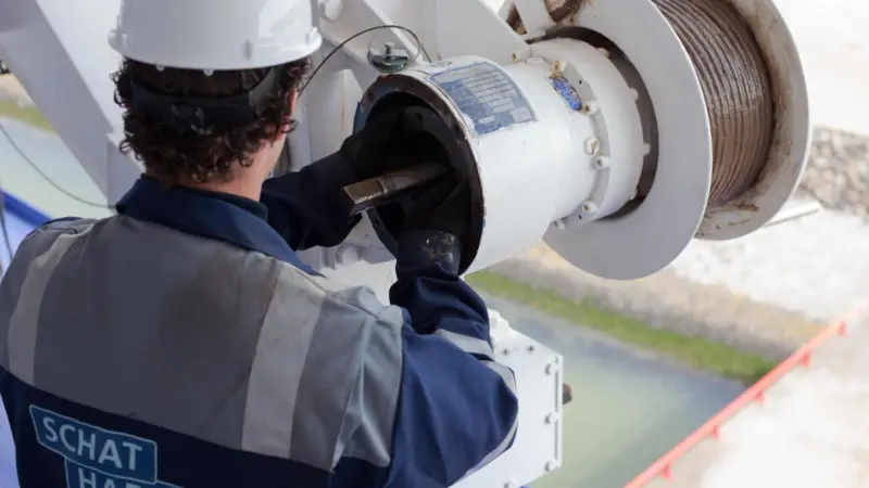 An engineer from Schat-Harding attends to maintenance of lifeboat mechanisms