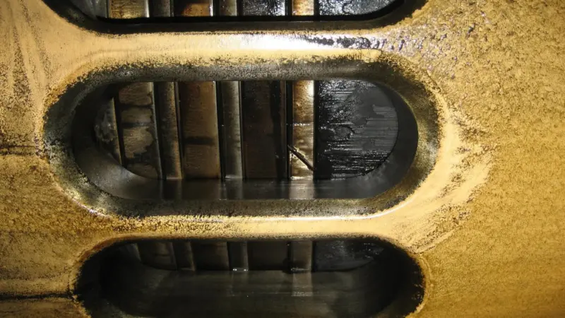 Piston with rings, as seen through scavenge ports (GL)