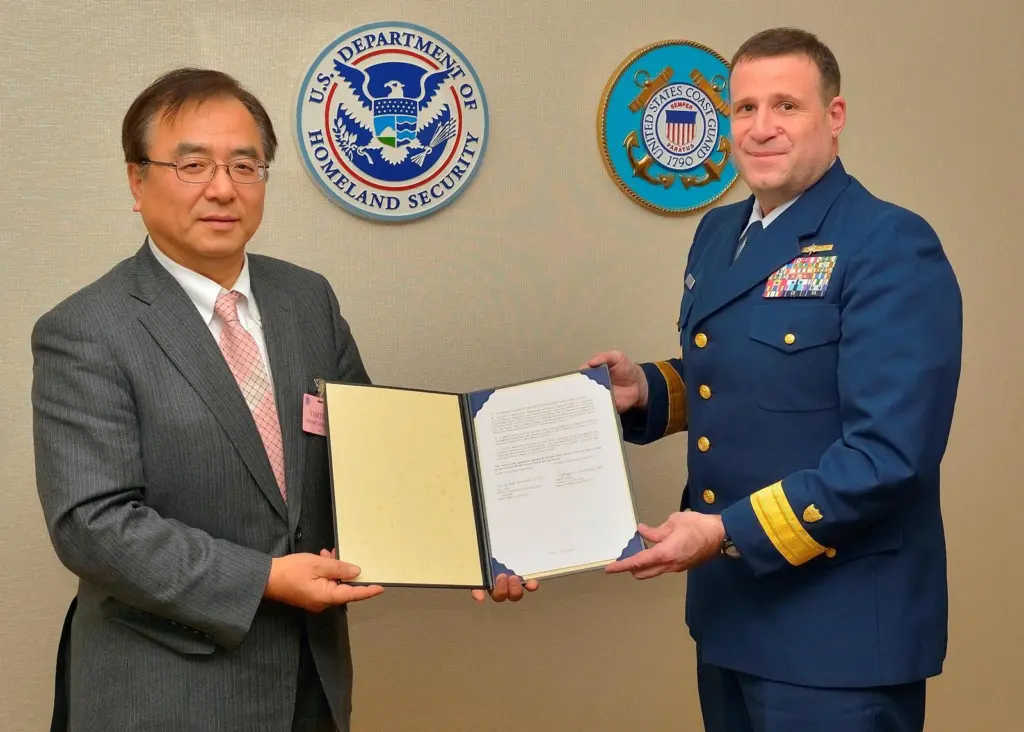 ClassNK executive vice president Dr Takuya Yoneya (L) receives a copy of the recognized organization agreement from U.S. Coast Guard Rear Admiral Joseph A. Servidio (R)