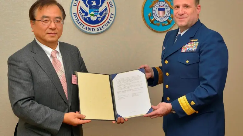 ClassNK executive vice president Dr Takuya Yoneya (L) receives a copy of the recognized organization agreement from U.S. Coast Guard Rear Admiral Joseph A. Servidio (R)