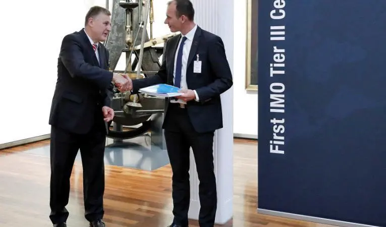 Kasper Moos, DFDS head of technical organisation (right) and Arnd Löttgen, member of the executive board, MAN Diesel & Turbo with the Tier III compatibility certificate from DNV GL