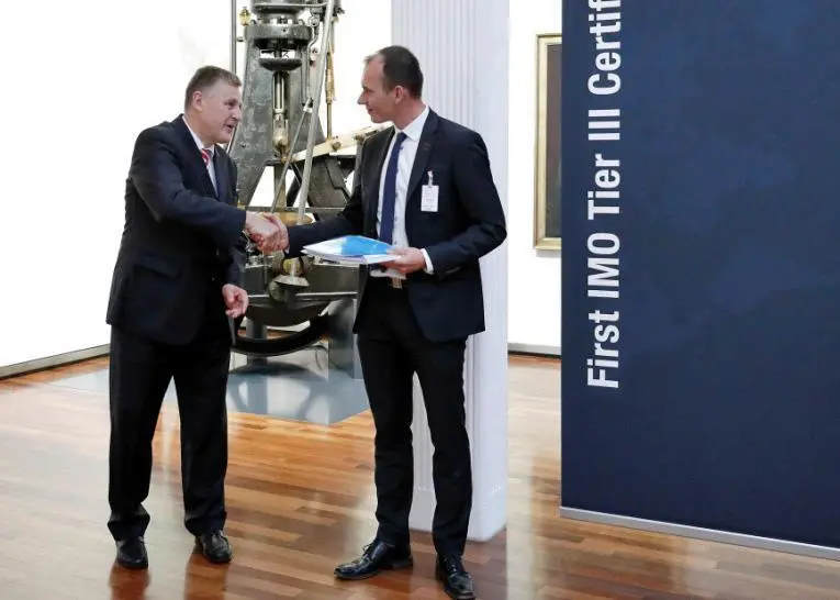 Kasper Moos, DFDS head of technical organisation (right) and Arnd Löttgen, member of the executive board, MAN Diesel & Turbo with the Tier III compatibility certificate from DNV GL