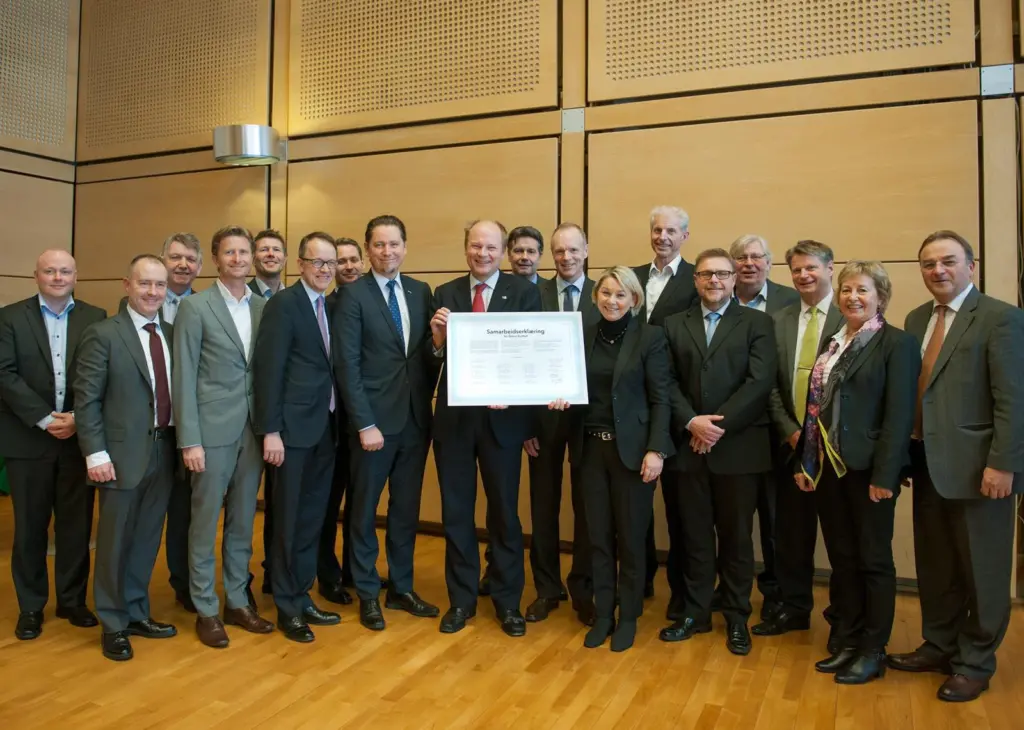 Partners including Lars Andreas Lunde, Norwegian state secretary for climate and environment (holding the declaration), Monica Mæland, minister of trade and industry (right), and Remi Eriksen. deputy group chief executive DNV GL (left) signed a ...
