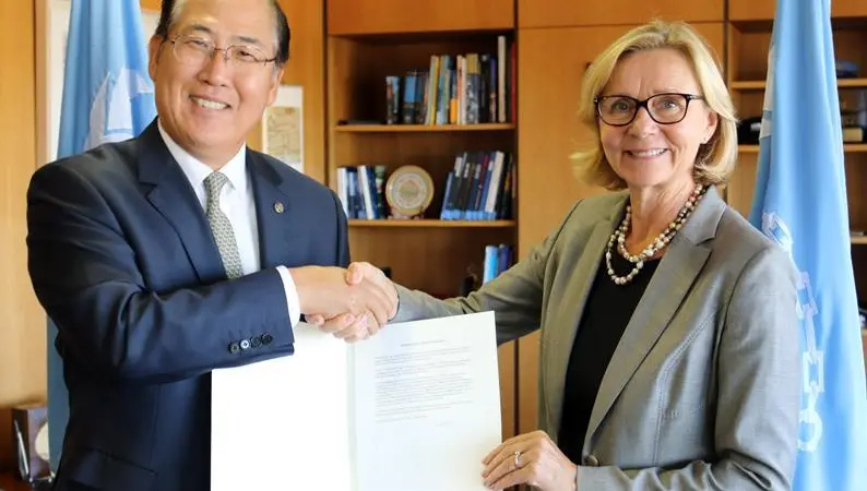 Päivi Luostarinen, permanent representative of Finland to IMO, hands the country's instrument of acceptance to Kitack Lim, secretary general, IMO