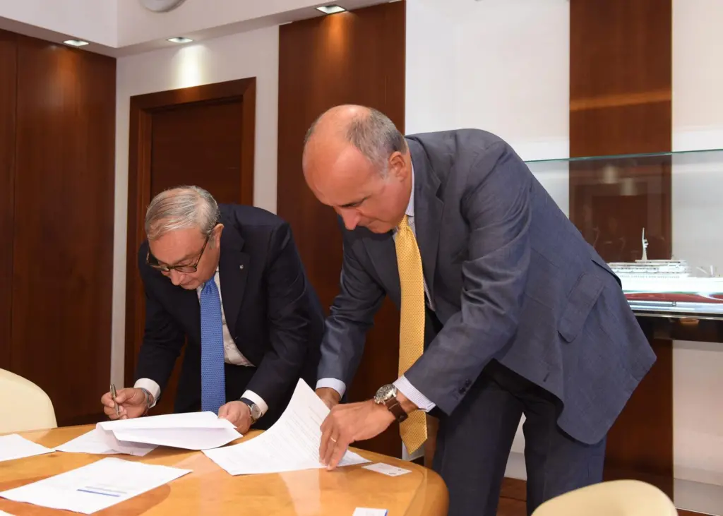 Giuseppe Bono, CEO, Fincantieri and Sandro De Poli, president and CEO, GE Italy agree to develop the Shipboard Pollutant Removal System