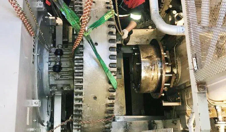 Burckhardt Compression experts working on the compressor skid in the confines of the compressor machinery room (CMR)