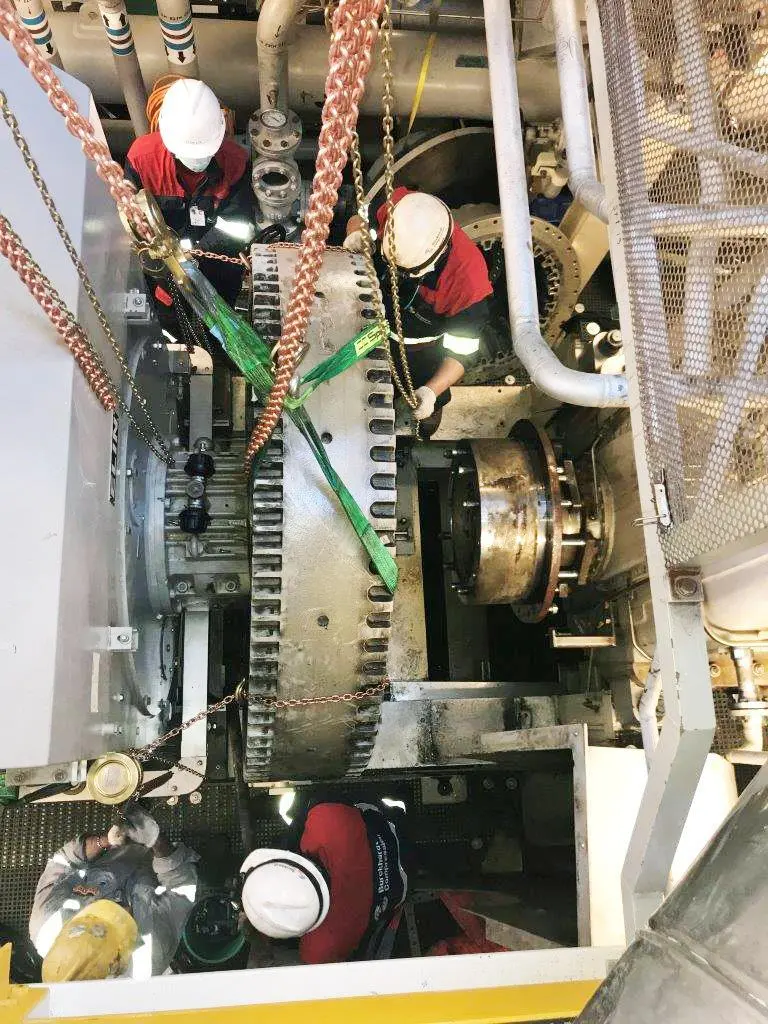 Burckhardt Compression experts working on the compressor skid in the confines of the compressor machinery room (CMR)