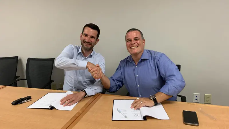 Bernd Siebert (left) – Head of Retrofit & Upgrades – pictured signing the MoU on behalf of MAN Energy Solutions with Giovanni Canu – Vice President Energy Assets and Fleet Decarbonization, NCL