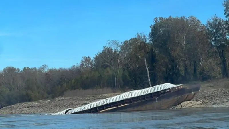 A barge that grounded and partially sank following the Marquette Warrior’s loss of steering.