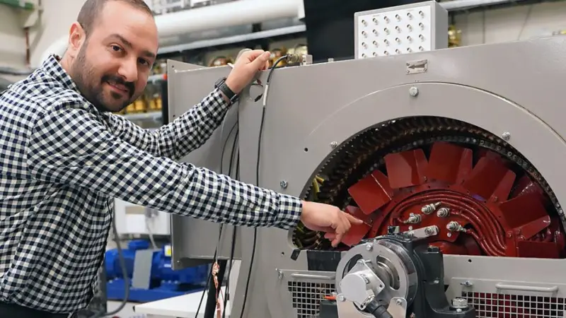 Hossein Ehya, a researcher at Norway's NTNU, alongside a purpose built generator model in NTNU’s SmartGrid laboratory.