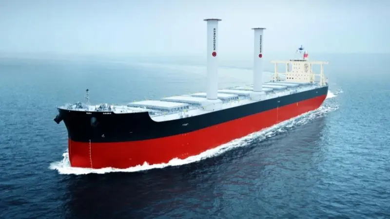 The image shows the vessel Camellia Dream at sea equipped with Norsepower rotor sails