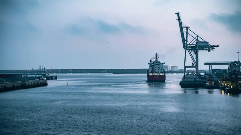Ship coming into port with crane on the right