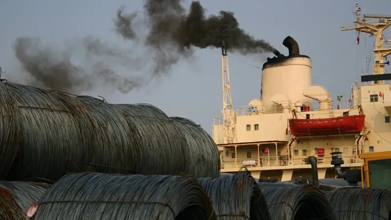 A ship emitting black smoke