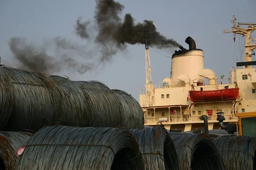 A ship emitting black smoke