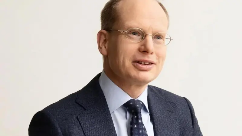 A head and shoulders image of Mr Agnevell, dressed in a blue suit, blue tie and white shirt