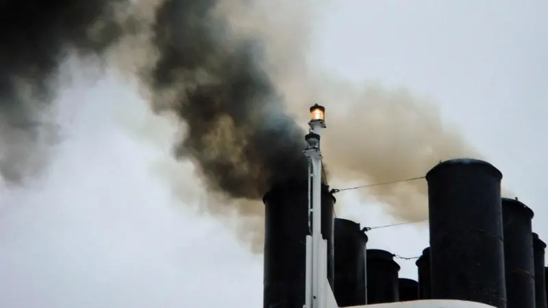 Ship emitting black smoke