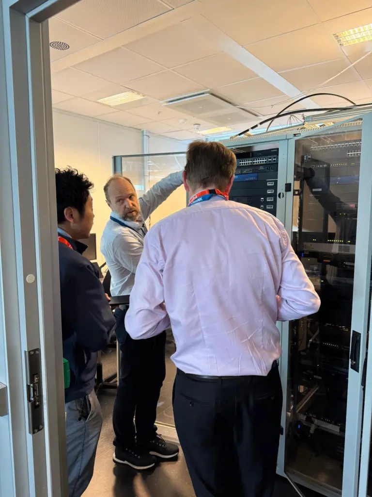 Three men looking at some equipment