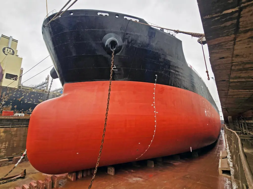 A red and black hull coated with Nippon Paint Marine hull coating