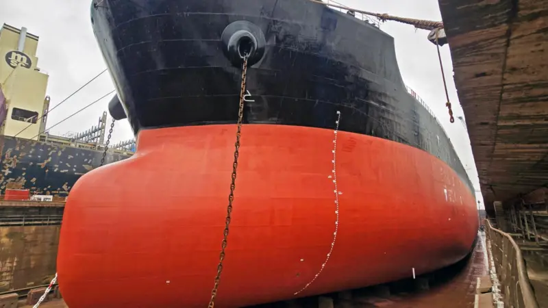 A red and black hull coated with Nippon Paint Marine hull coating